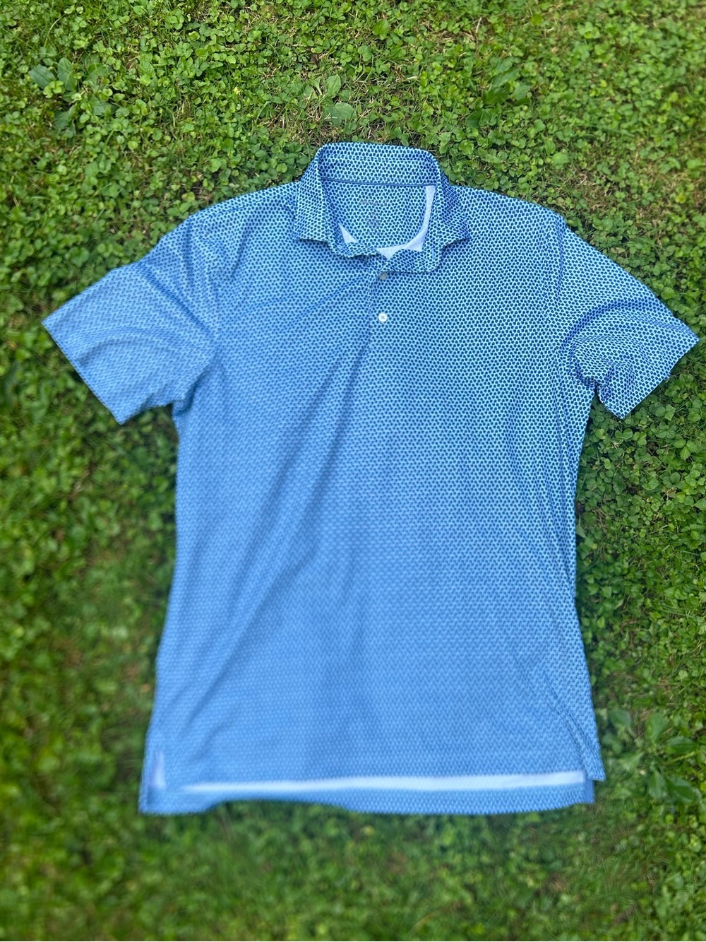 Johnnie-O blue patterned performance polo shirt with a geometric micro-print